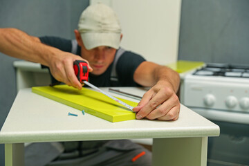 Wall Mural - worker measuring furniture part close up