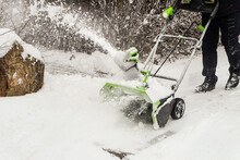 Wireless Electric Snow Blower At Work. Rechargeable Battery Machine.