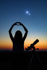 Wall Mural - woman looking at night sky with amateur astronomical telescope.