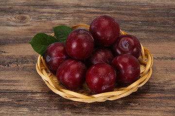 Plum heap in the wooden basket