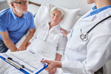 Poster - medicine, age, health care and people concept - senior woman, man and doctor with clipboard at hospital ward