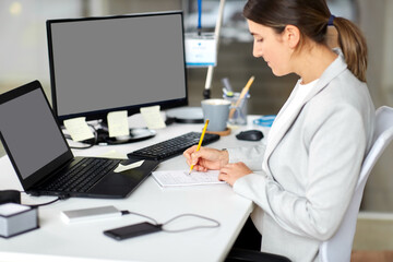 Sticker - business, technology and people concept - businesswoman with notebook and laptop computer working at office