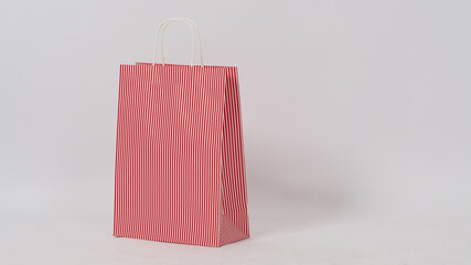 Red stripe Empty Shopping Bag is isolated on White background.copy space and no people.