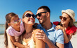 © Syda Productions - family, leisure and people concept - portrait of happy mother, father and two daughters in sunglasses on summer beach