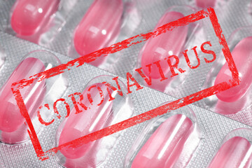 Poster - red stamp with the inscription coronavirus on the background of a blister with pills