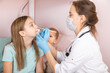 © Dmitry Naumov - Pediatrician taking nasal test sample from child at home during lockdown
