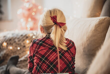 Cute Blond Girl Portrait In Front Of Pink Christmas Tree With Fairy Lights