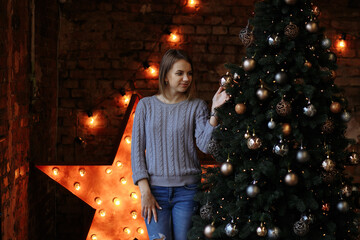 Wall Mural - girl with christmas decorated tree