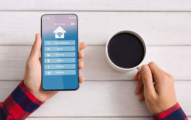 Poster - Man Controlling Smart Home Processes With App On Smartphone And Drinking Coffee