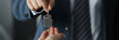 © H_Ko - Man in business suit hands overing house keys to woman closeup. Social assistance in construction concept