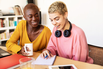 Girls drinking coffee and shopping online on laptop