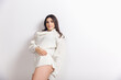 © master1305 - Attractive. Portrait of beautiful brunette woman in comfortable soft longsleeve isolated on white studio background. Home comfort, emotions, facial expression, winter mood concept. Copyspace.