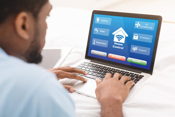 Poster - Black Man Using Laptop With Smart Home Control System On Screen, Collage