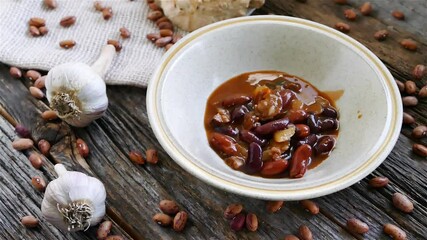 Wall Mural - Adding home made beans soup with sausages inside bowl