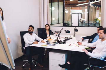 Wall Mural - Focused diverse coworkers discussing strategy