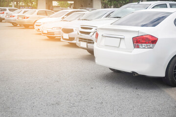 Wall Mural - Car parked in large asphalt parking lot in a row background. Outdoor parking lot, travel transportation business concept