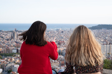 Two girls looking at the city and having fun