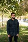 Fototapeta Młodzieżowe - Autumn lifestyle, Bearded man standing in outdoors park
