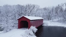 Snowflakes Fall At Red Covered Bridge In Iowa