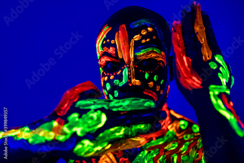 Plakat afro american man posing in studio shot with UV light