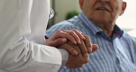 Wall Mural - Female doctor in white coat hold 70s senior patient hand for encouragement, express empathy, show support during medicine examination, close up. Medical help, insurance for older, healthcare concept