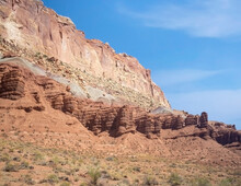 Sublime Monoliths And Towering Sandstone Cliffs On A Hot Partly Cloudy Summer Day At Capitol Reef National Park In Southern Utah.
