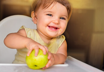 baby with an apple.