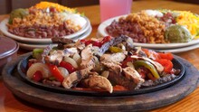 Sizzling Beef And Chicken Fajita Combo Platter With Sides, Close Up Slider Slow Motion 4K