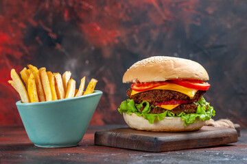 front view tasty meat burger with french fries on a dark background sandwich fast-food bun