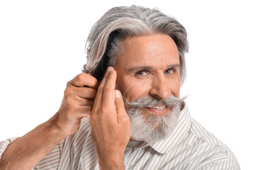 Canvas Print - Mature man combing hair on white background