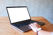 © Farknot Architect - Mockup image of a woman using and touching on laptop computer touchpad with blank white desktop screen on the table