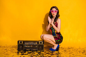 Wall Mural - Full body photo cute shocked girl sit floor confetti with rhythm boom box make her lips pouted plump wear skirt blue stilettos heart shape sunglass isolated bright shine color background