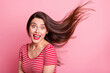 Portrait of young beautiful excited smiling good mood girl open mouth flying hair isolated on pink color background