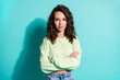 © deagreez - Photo portrait of serious independent woman with folded hands isolated on vivid turquoise colored background