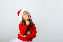 Girl In A Santa Hat On A White Background