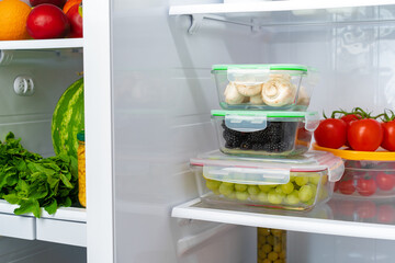 Storage containers with fresh food in a fridge