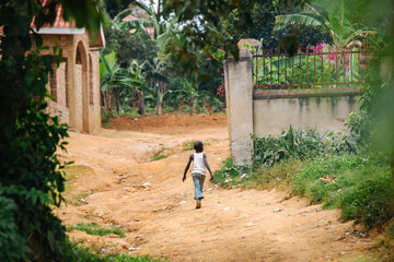 Wall Mural - boy running in Uganda, Africa