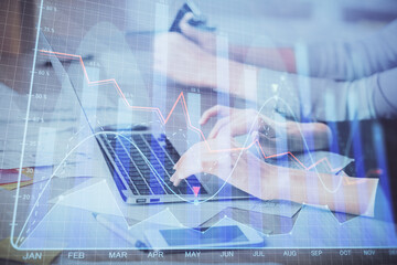 Multi exposure of woman hands typing on computer and financial chart hologram drawing. Stock market analysis concept.