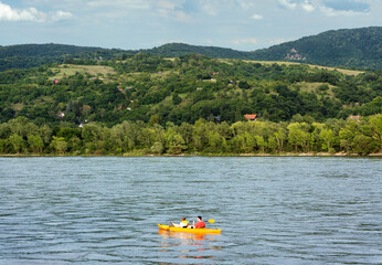 Kayak on the river against green hills