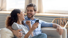 Wide Banner Panoramic View Of Overjoyed Millennial Couple Celebrate Online Win On Cellphone Together. Happy Young Caucasian Man And Woman Triumph With Good Sale Deal Or Promotion Discount On Cell.