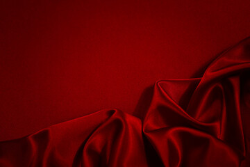 Black red silk satin background. Copy space for text or product. Wavy soft folds on shiny fabric. Luxurious dark red background. Valentine, Christmas, Anniversary, Holiday, Celebration, Black Friday.