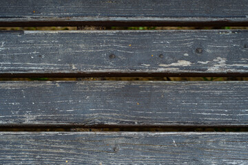 Wall Mural - The back of an old wooden bench. Background with loose old wooden planks with peeling paint.