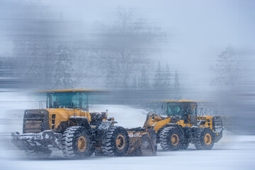 Wall Mural - blurred view of big excavators at worksite  