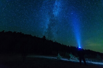 Wall Mural - fantastic starry night with galaxy milky way with a tourist and a tent on the mountain range in the 