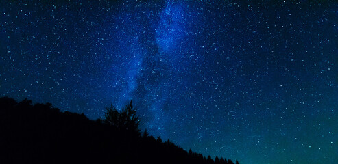 Wall Mural - fantastic starry night with galaxy milky way with a tourist and a tent on the mountain range in the 
