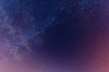 Wall Mural - a magical starry night on the river bank with a large tree and a milky way in the sky and falling st