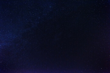 Wall Mural - a magical starry night on the river bank with a large tree and a milky way in the sky and falling st