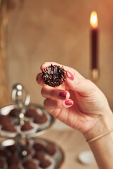 Wall Mural - Selective focus shot of a female hand holding a bitten delicious Brazilian Brigadeiro