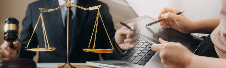 Business and lawyers discussing contract papers with brass scale on desk in office. Law, legal services, advice, justice and law concept picture with film grain effect