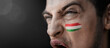 © butenkow - A screaming man with the image of the country's national flag on his face
